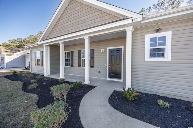 view of exterior entry featuring a porch