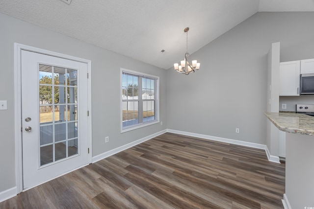 unfurnished dining area featuring an inviting chandelier, lofted ceiling, dark wood-style floors, and baseboards