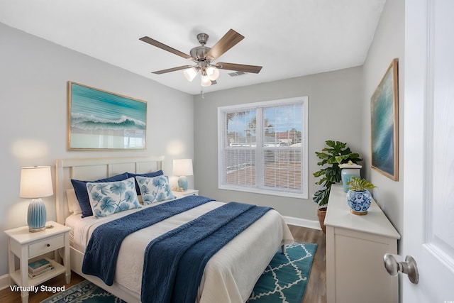 bedroom with visible vents, ceiling fan, dark wood-type flooring, and baseboards