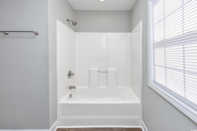 bathroom with baseboards and shower / tub combination