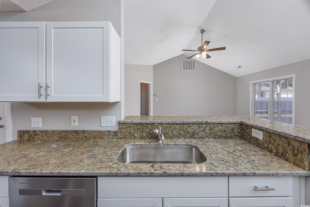 kitchen featuring dishwasher, light stone counters, visible vents, and a sink