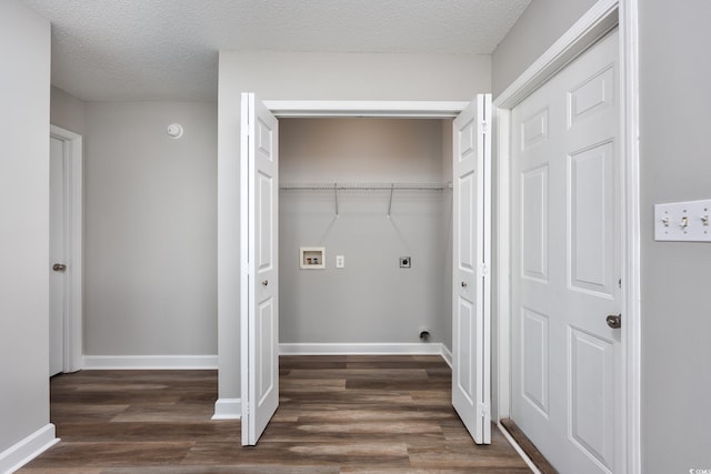 washroom with electric dryer hookup, dark wood finished floors, baseboards, hookup for a washing machine, and laundry area