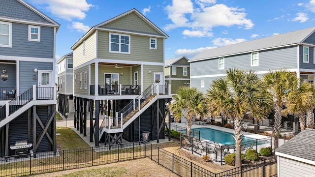 rear view of house with a patio area, a fenced backyard, stairs, and a fenced in pool