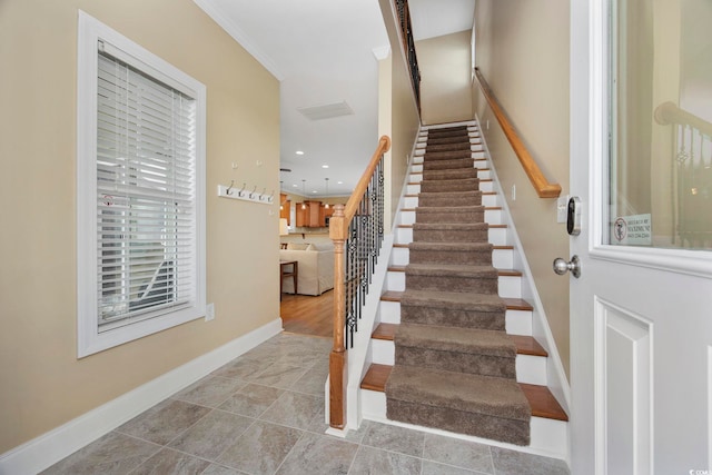 staircase with crown molding, recessed lighting, tile patterned flooring, and baseboards