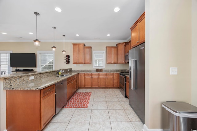 kitchen with stainless steel appliances, a peninsula, a sink, light stone countertops, and brown cabinetry