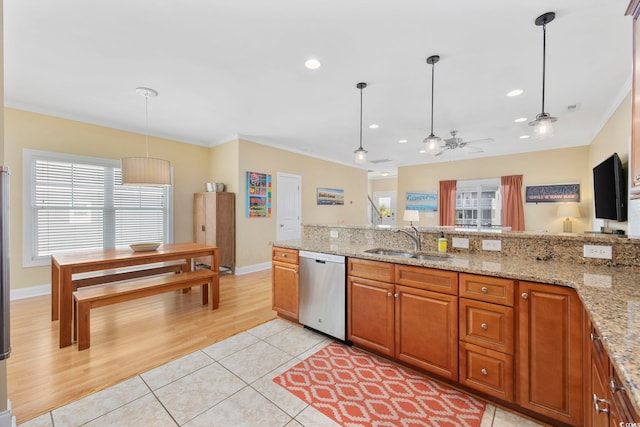 kitchen featuring dishwasher, light tile patterned floors, a sink, and crown molding