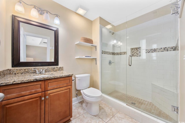 bathroom featuring tile patterned flooring, toilet, vanity, baseboards, and a stall shower