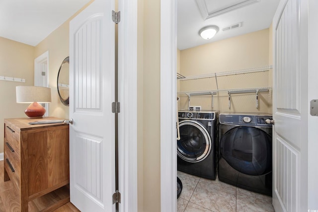 laundry area with washer and dryer, laundry area, visible vents, and light tile patterned floors