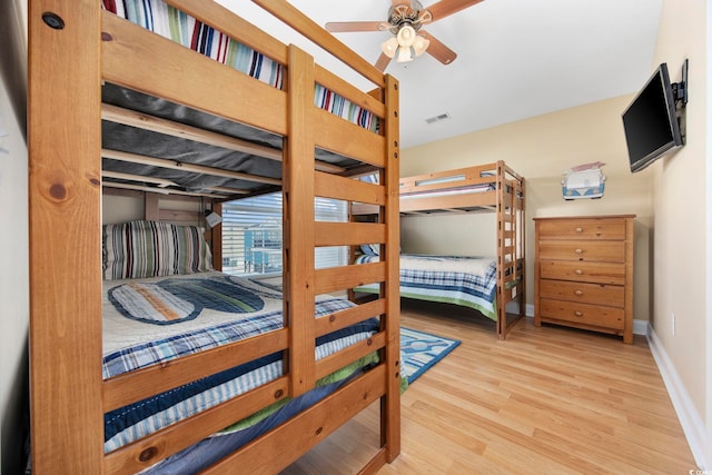 bedroom featuring baseboards, visible vents, ceiling fan, wood finished floors, and access to exterior