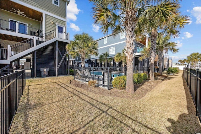 exterior space featuring a swimming pool and fence