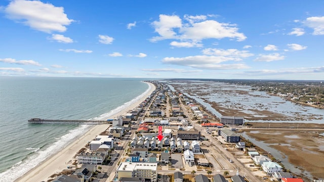 drone / aerial view featuring a water view and a view of the beach