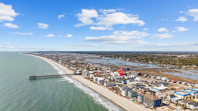 aerial view with a water view and a beach view