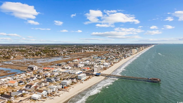 drone / aerial view featuring a water view and a view of the beach