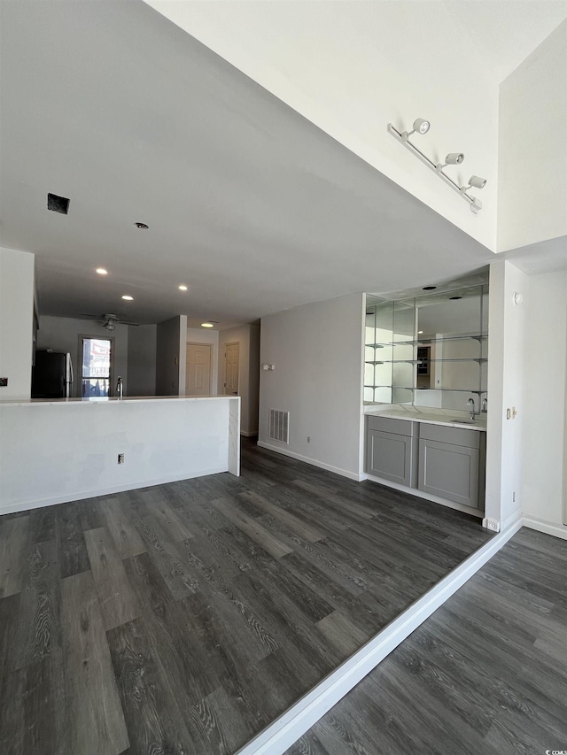 4396 Baldwin Ave Unit 141, Little River, SC 29566 - unfurnished living room with dark wood finished floors, a sink, baseboards, and recessed lighting
