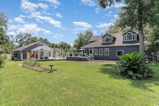 view of yard with a wooden deck and a vegetable garden