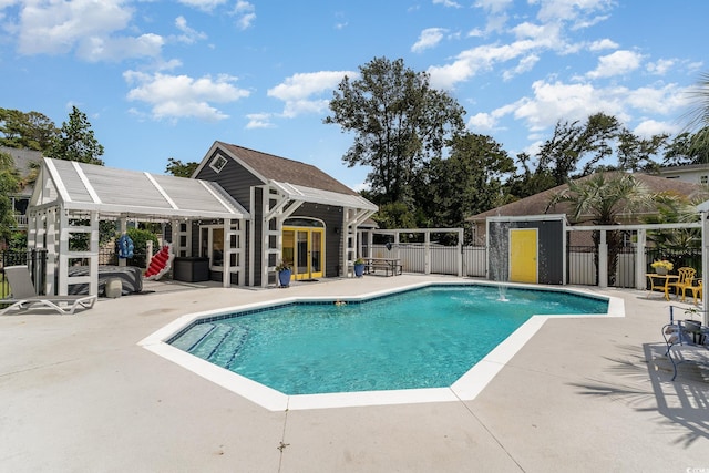 view of pool with a patio, fence, a fenced in pool, an outdoor structure, and french doors