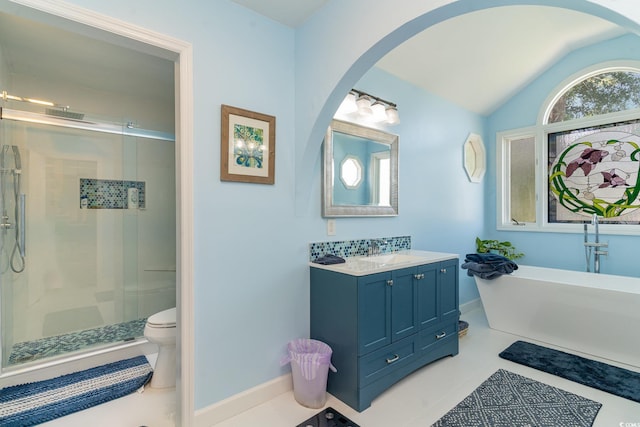 full bathroom with toilet, a shower stall, lofted ceiling, a soaking tub, and vanity