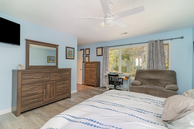 bedroom featuring ceiling fan, baseboards, visible vents, and light wood-type flooring