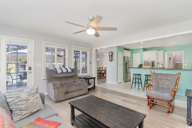 living room featuring recessed lighting, baseboards, light wood-type flooring, and ceiling fan