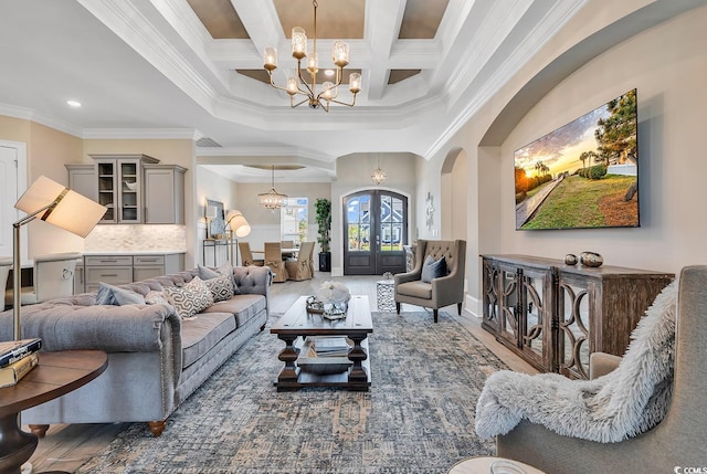 410 44th Ave N, Myrtle Beach, SC 29577 - living room with a chandelier, crown molding, arched walkways, wood finished floors, and coffered ceiling