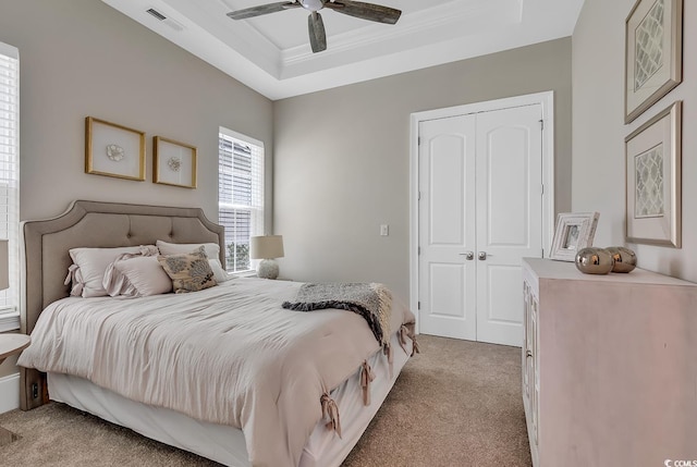 410 44th Ave N, Myrtle Beach, SC 29577 - bedroom with light carpet, a closet, a tray ceiling, ceiling fan, and ornamental molding