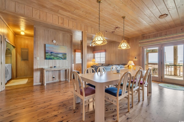 dining area with washer / dryer, light wood-type flooring, wooden ceiling, and a healthy amount of sunlight