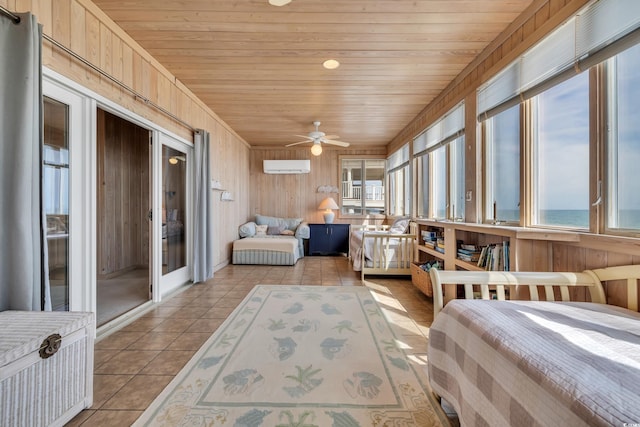 bedroom featuring an AC wall unit, light tile patterned flooring, wooden ceiling, and wood walls