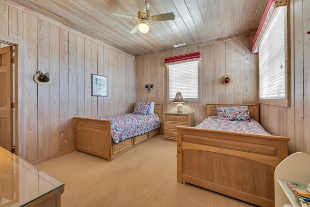 carpeted bedroom with wooden ceiling, a ceiling fan, and wood walls