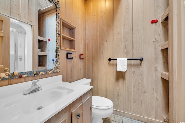 bathroom featuring toilet, vanity, and tile patterned floors