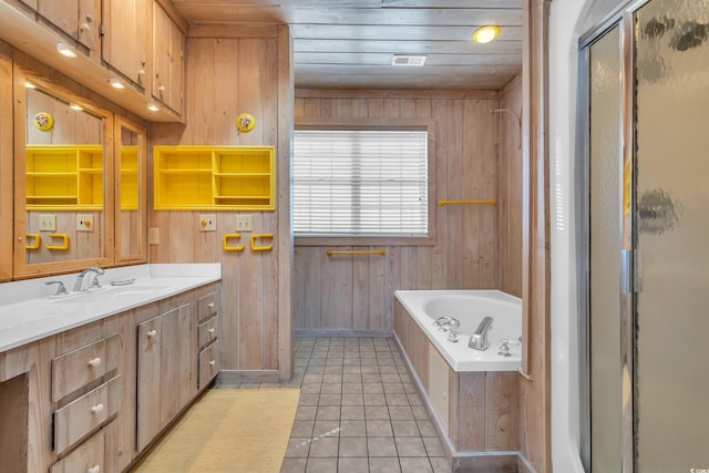 full bathroom featuring a garden tub, a stall shower, wooden walls, vanity, and tile patterned flooring