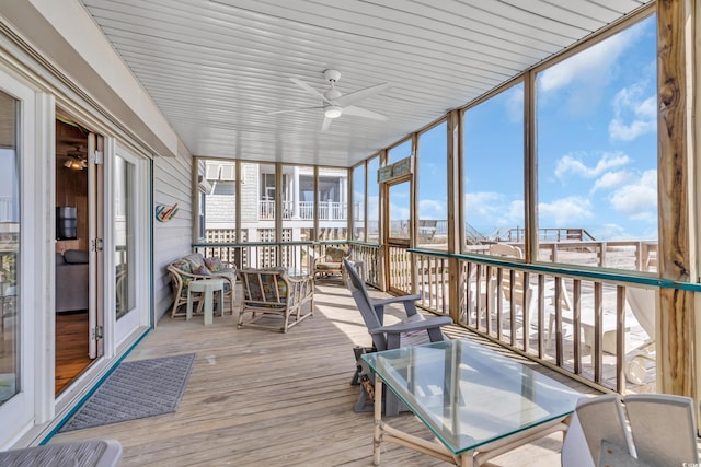 unfurnished sunroom with a ceiling fan