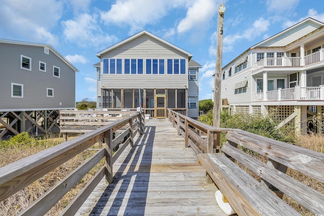 rear view of property featuring a sunroom