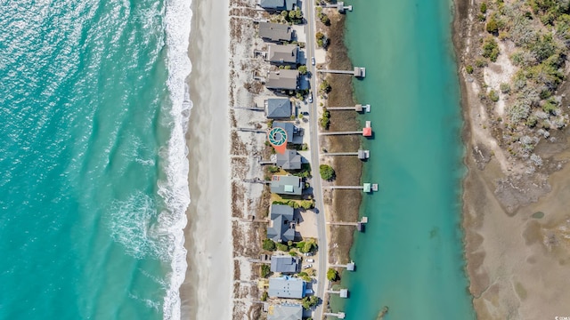 aerial view featuring a water view and a beach view