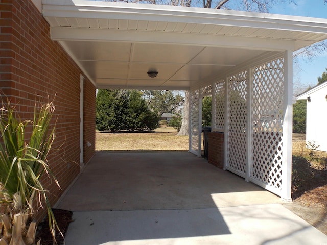 view of patio / terrace featuring an attached carport and driveway