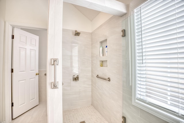 bathroom with vaulted ceiling and a stall shower