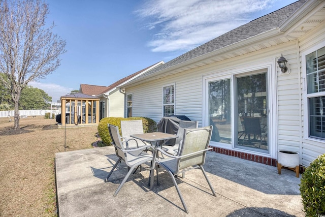 view of patio with outdoor dining space, a playground, and fence