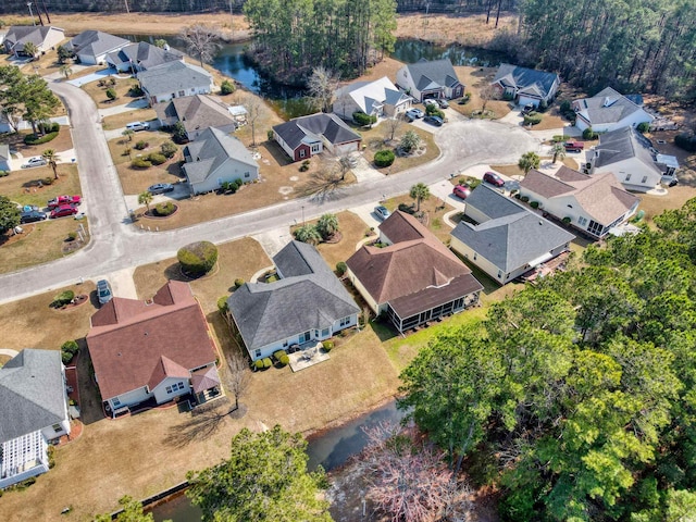 drone / aerial view with a residential view and a water view