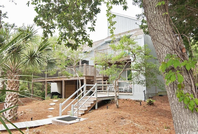 back of property with stairway and a wooden deck