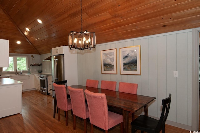 dining space with a notable chandelier, wood ceiling, wood finished floors, and vaulted ceiling