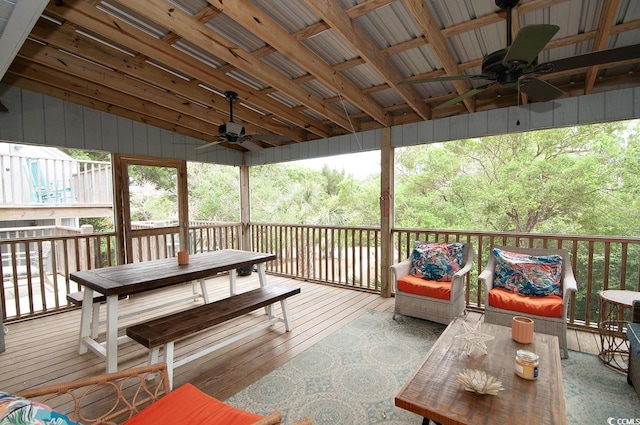 wooden deck with a wooded view and ceiling fan