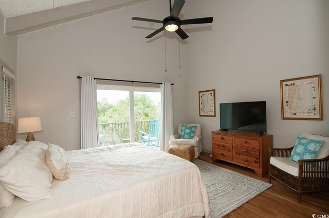 full bath featuring a shower stall, baseboards, double vanity, wood finished floors, and a sink