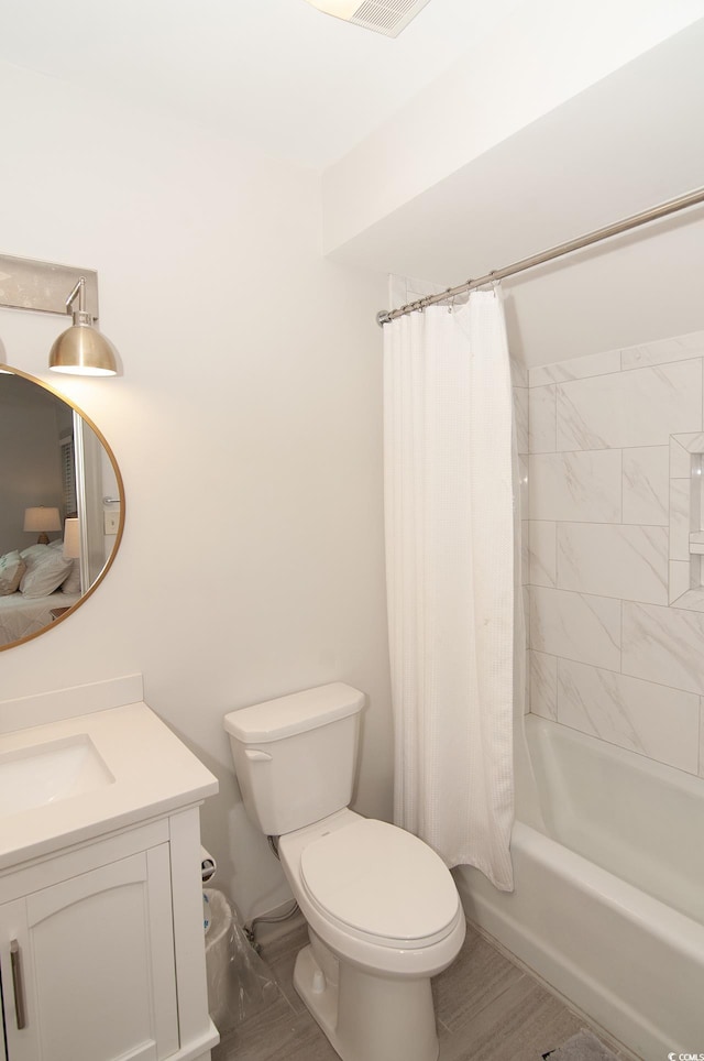 bathroom featuring vanity, toilet, and shower / tub combo with curtain