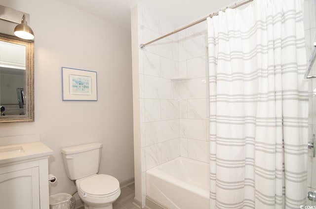 bathroom featuring vanity, shower / bath combination with curtain, and toilet