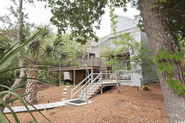 rear view of property with a deck and stairway