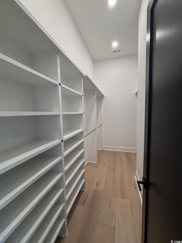 spacious closet with visible vents and wood finished floors