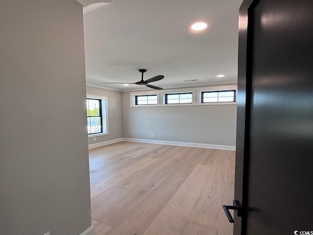 unfurnished room with ceiling fan, light wood finished floors, recessed lighting, and baseboards