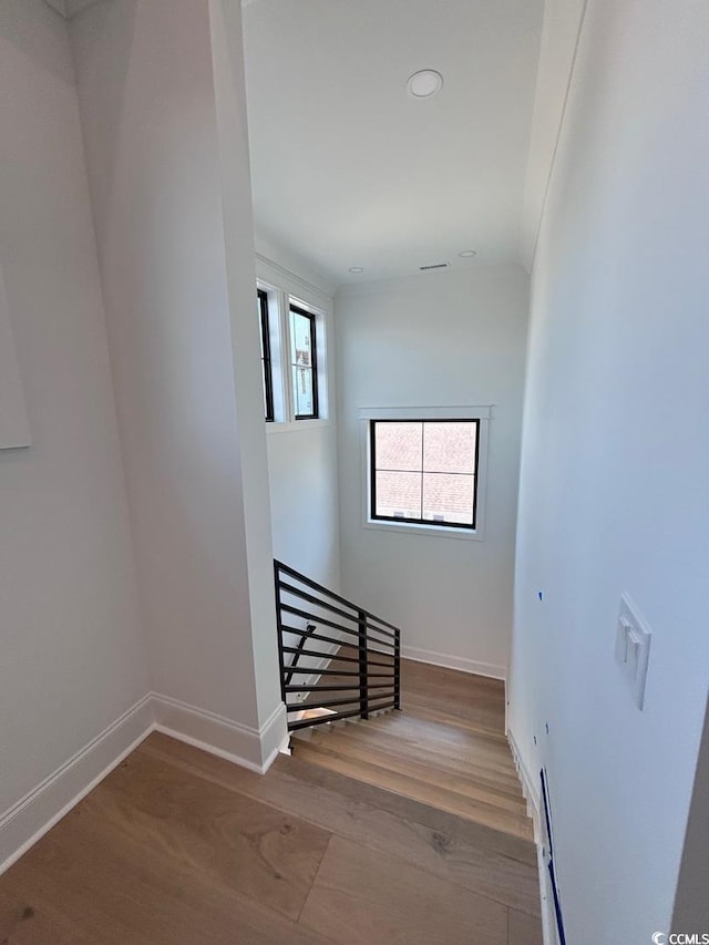 stairs with baseboards and wood finished floors