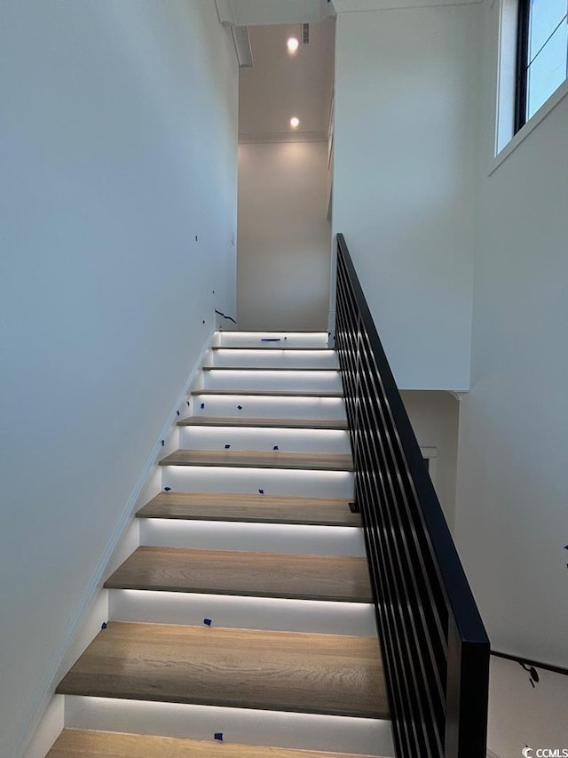 stairs featuring recessed lighting