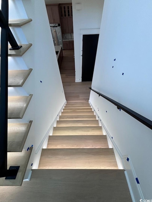 staircase with wood finished floors