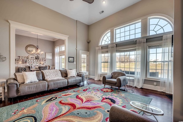 1624 Portwest Dr, Myrtle Beach, SC 29579 - living room with healthy amount of natural light, a chandelier, wood finished floors, a high ceiling, and a ceiling fan